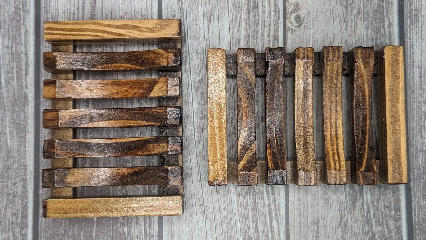 Handcrafted wooden soap dishes with slatted design on rustic wood background